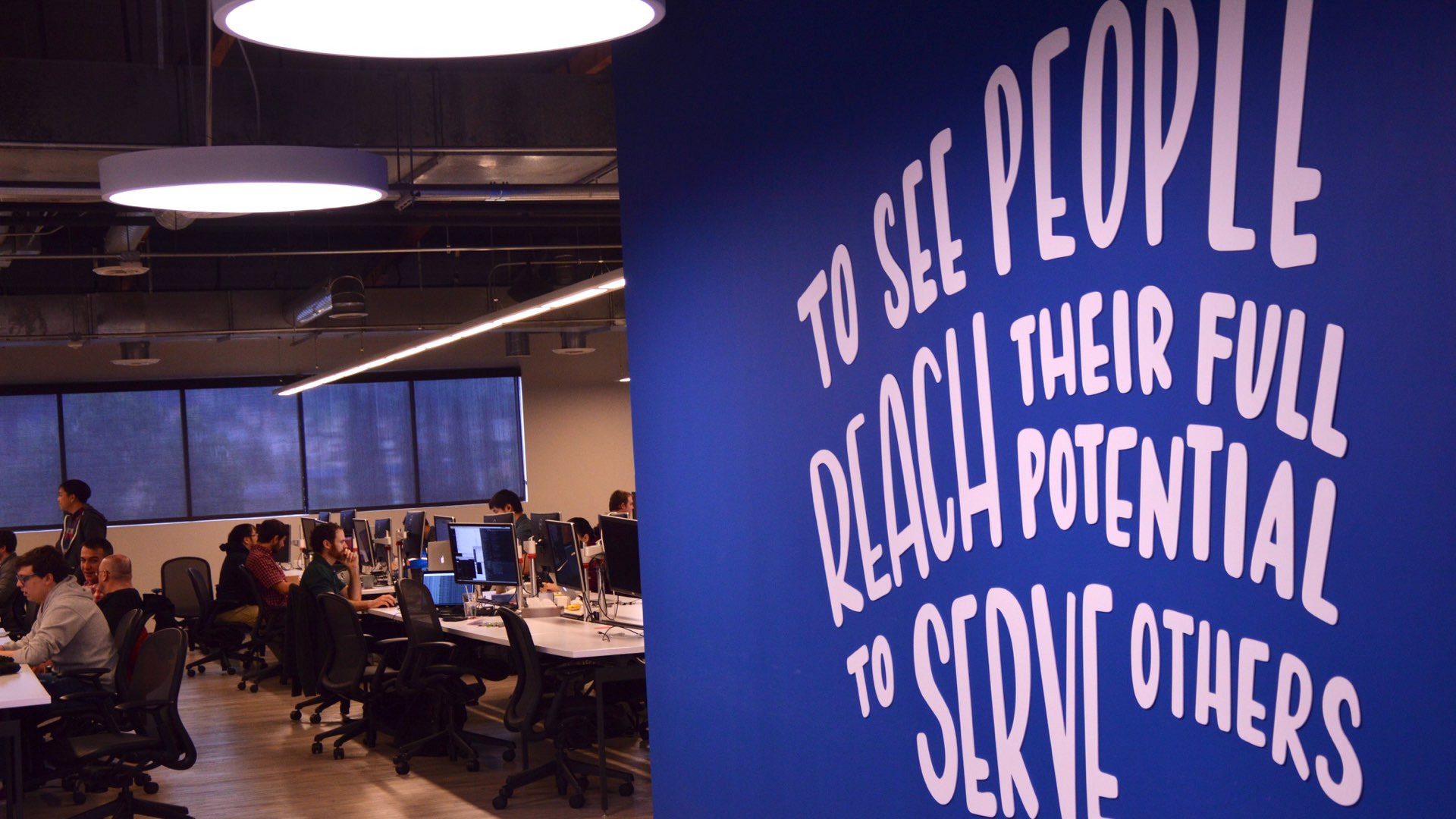 Liferay's office wall saying “to see people reach their full potential to serve others“